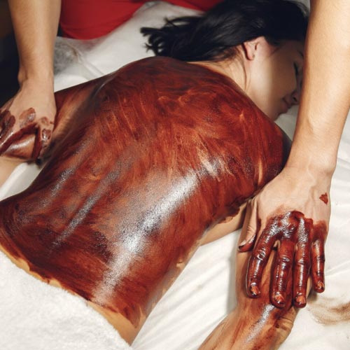 Relaxing algae body wrap treatment applied to a client’s back.